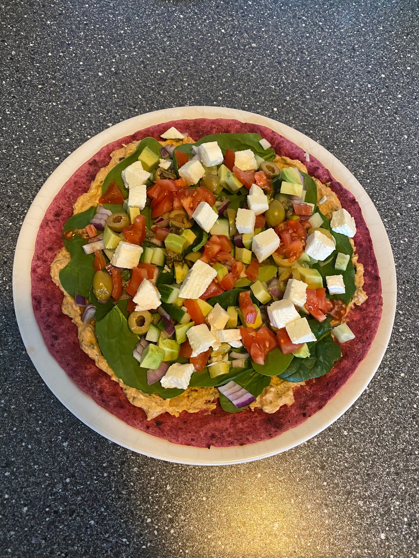 Een platbrood met feta, komkommer en tomaat